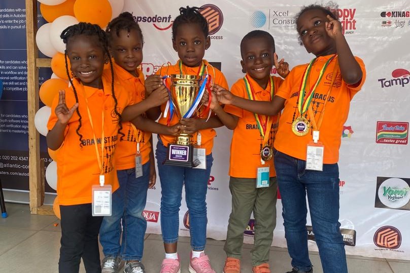 five students with a trophy and medals