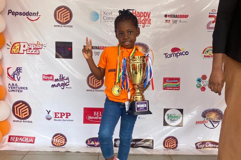 female student with a trophy and medal