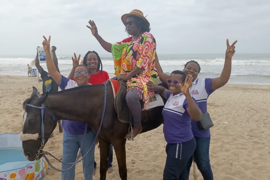 teacher on horse with staff gathered around