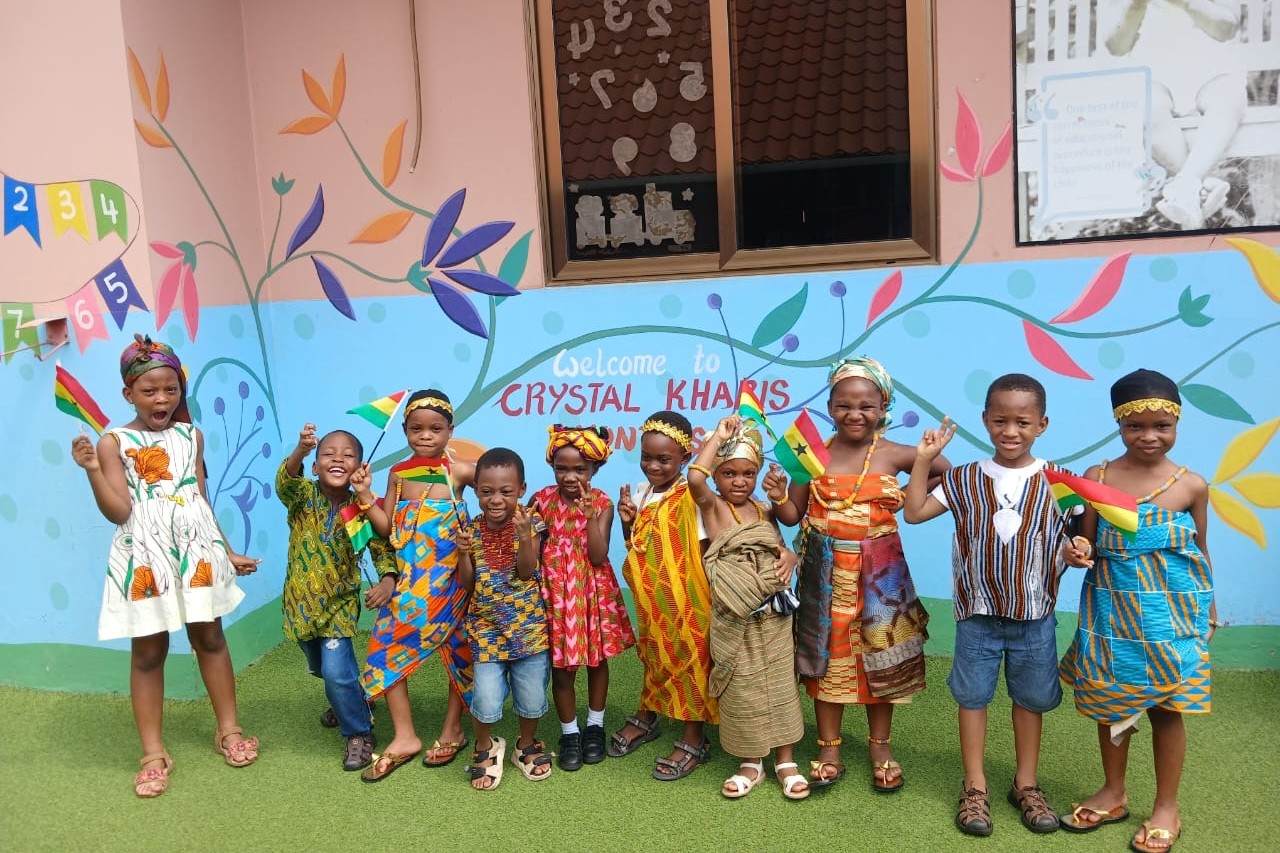 three students with a trophy and medals